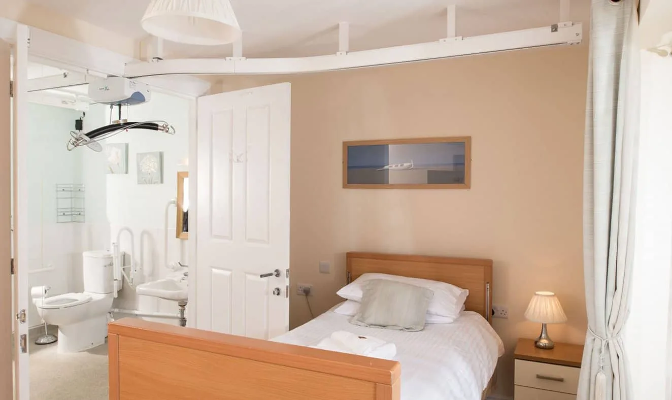 Wheelchair friendly bedroom with space around the bed and reachable sockets